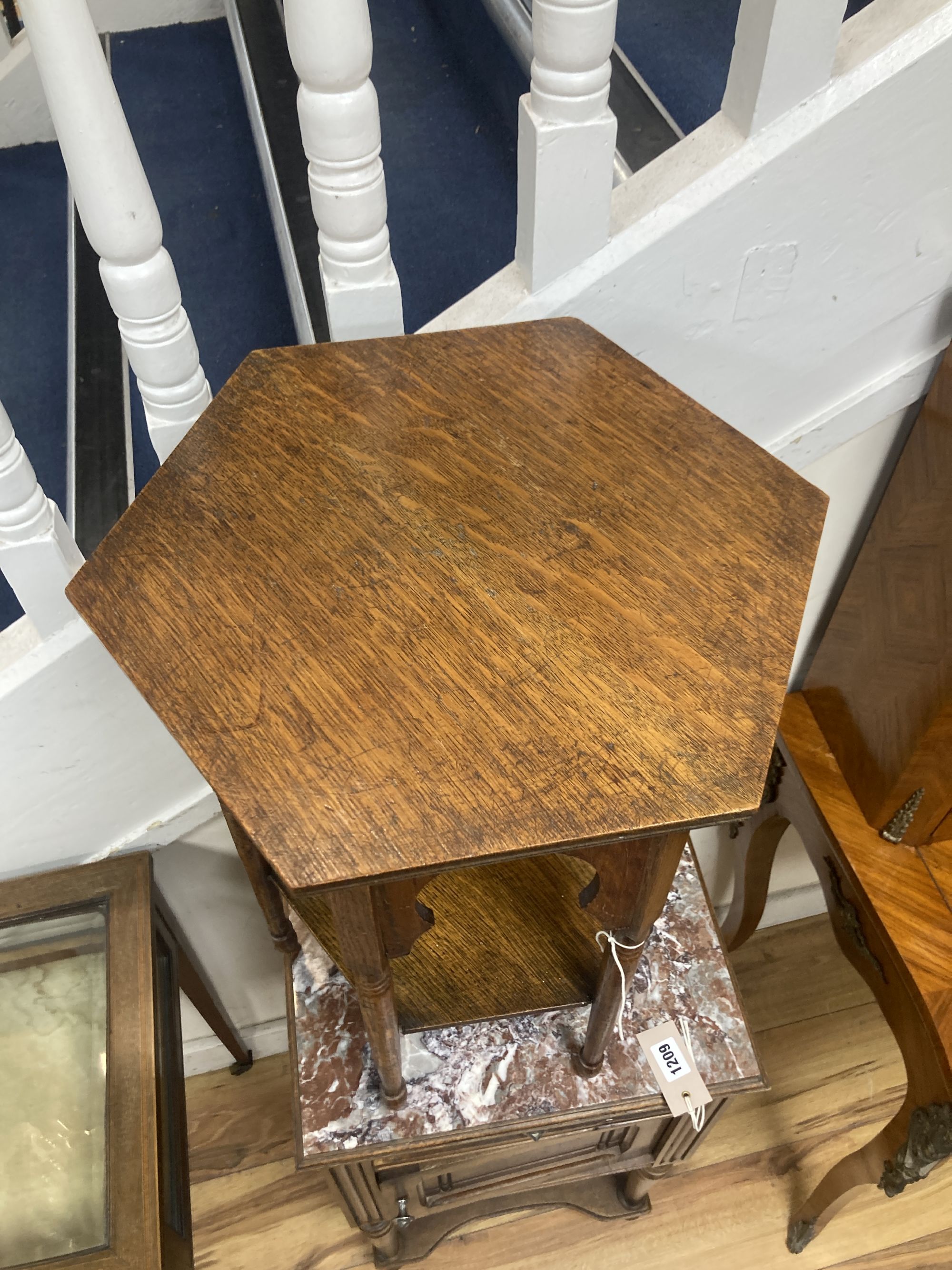 An early 20th century Moorish style hexagonal oak occasional table, width 36cm, height 51cm